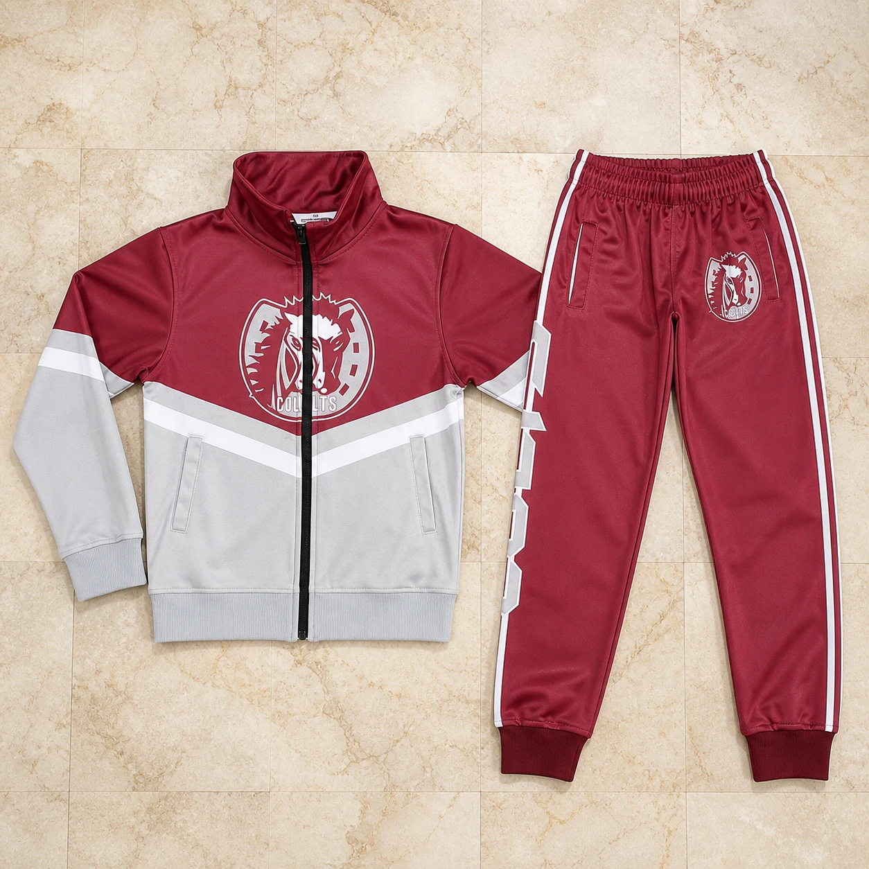 Red and white custom tracksuit set shown on a marble background